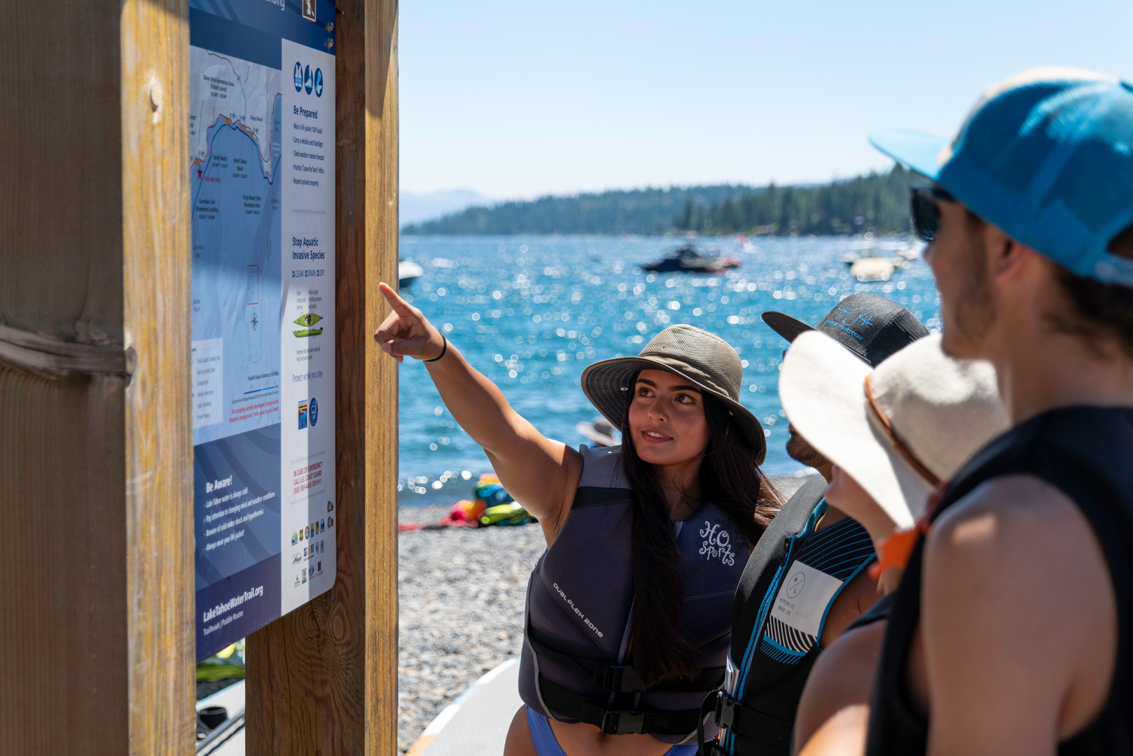 A group of friends looking at the Lake Tahoe Water Trail head sign