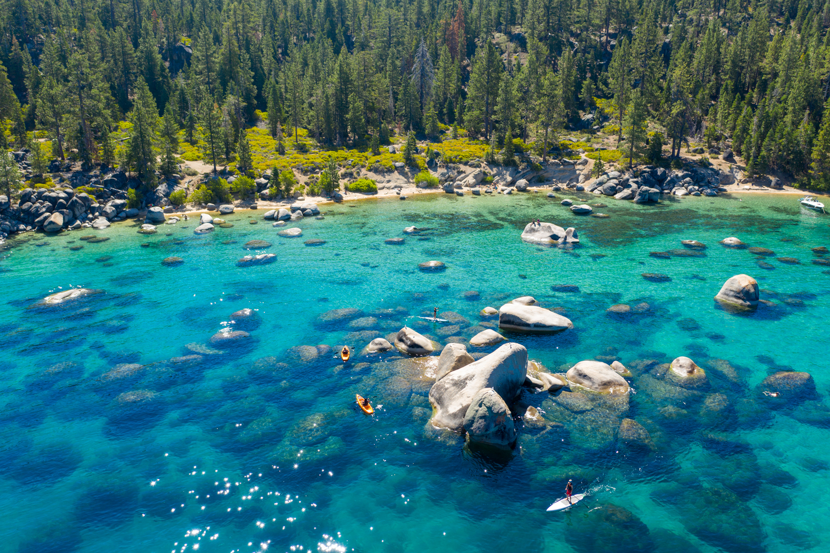 Whale beach on Lake Tahoe on a sunny summer day with kayakers and paddlers