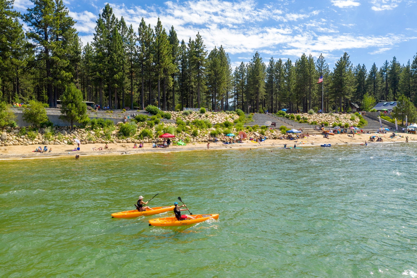 Kayakers paddling by El Dorado Beach / Lakeview Commons in South Lake Tahoe